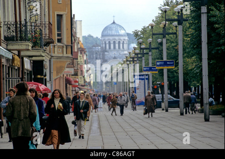 Kaunas, Lituanie. Les gens qui marchent dans la rue avec rangée de lampadaires, l'Église orthodoxe russe dans le centre. Banque D'Images