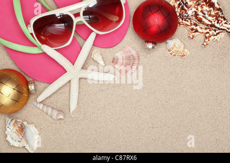 Boules de Noël,coquillages et avec accessoires de plage sur des sables,libre. Banque D'Images