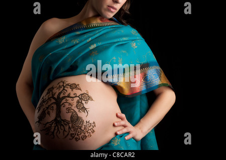 Une photo couleur de henné un 'arbre de vie' design sur une femme enceinte du ventre. Banque D'Images