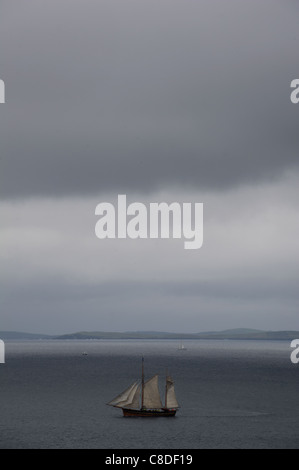 Un grand voilier quitte le port de Lerwick sur les îles Shetland en Écosse pendant la course des grands voiliers 2011. Banque D'Images