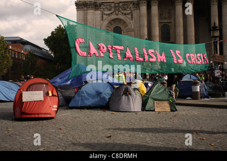 Une bannière et tentes appartenant à des manifestants anti-capitaliste à l'extérieur de la Cathédrale St Paul à Londres Banque D'Images