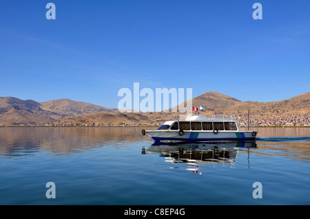 Bateau à moteur sur le lac Titicaca Puno avec en arrière-plan Banque D'Images