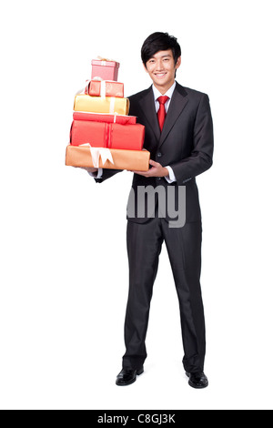Happy Businessman Holding a gift Banque D'Images