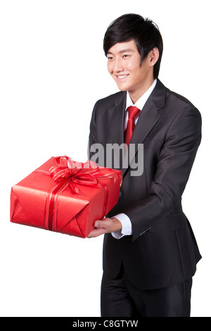 Happy Businessman Holding a gift Banque D'Images