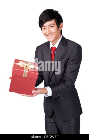 Happy Businessman Holding a gift Banque D'Images