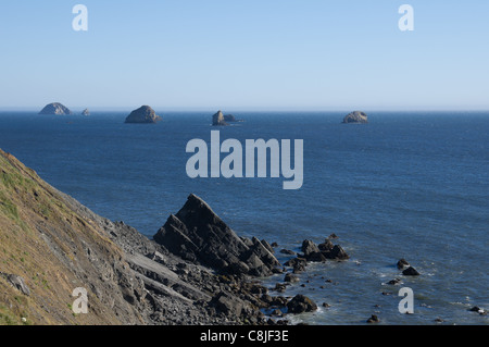 Lieu des formations de roche au large des côtes de l'océan avec banc de brouillard à l'arrière-plan Banque D'Images