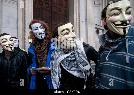 Occupy London au St Paul's - Anonymous, des manifestants portant des masques de Guy Fawkes en face de la cathédrale portes fermées Banque D'Images