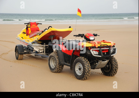 Cornwall, Angleterre. Un sauveteur RNLI's quad et jet ski PWC embarcation de sauvetage sur une plage de sable. Banque D'Images