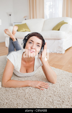 Portrait of a smiling brunette listening to music Banque D'Images