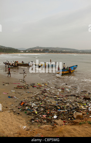 L'arrivée des bateaux à la plage jonchée de leur matinée de pêche avec filets assez vide Banque D'Images