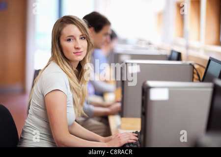 Blonde student using a computer Banque D'Images