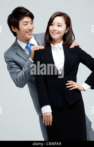 Asian Businesswoman and businessman standing Back To Back Banque D'Images