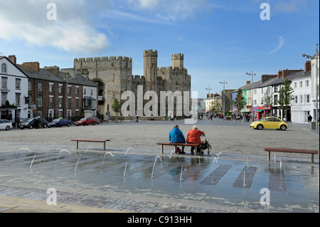 Deux dames âgées se détendre sur un banc de la place du château de Caernarfon gwynedd North Wales UK Banque D'Images