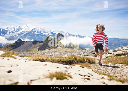 Boy running in paysage rocheux Banque D'Images