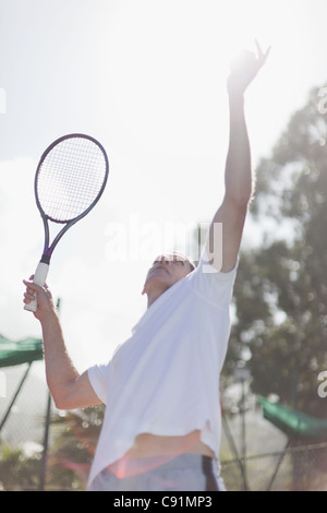 Balle de tennis au service de l'homme plus âgé Banque D'Images