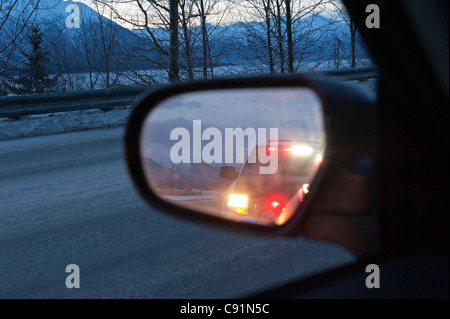 Les feux d'un véhicule de police de refléter dans le rétroviseur d'une voiture sur l'autoroute de Seward, Alaska, Turnagain Arm Banque D'Images