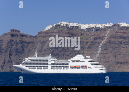 Santorin - bateau de croisière Silversea Silver Spirit amarré au-dessous de la ville de Fira. Banque D'Images