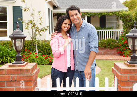 Hispanic couple outside new home Banque D'Images