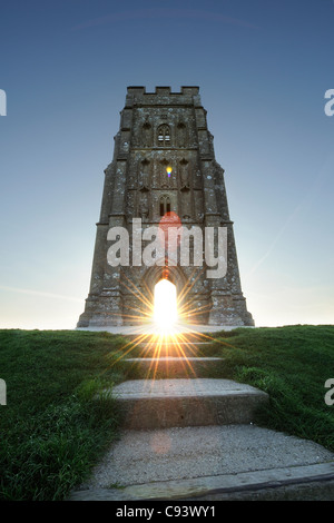 St Michael's tower au sommet de Tor de Glastonbury, Somerset, avec le soleil levant visible à travers l'arcade. Banque D'Images