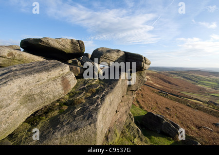 Stanage Edge pierre meulière rochers dans le parc national de Peak District Derbyshire tourné contre le ciel bleu Banque D'Images