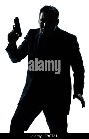 Portrait d'un criminel d'espionnage policier detective man holding gun portrait silhouette en studio isolé sur fond blanc Banque D'Images