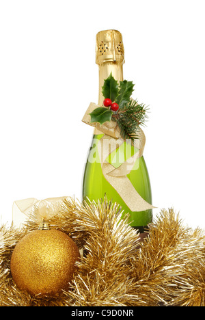 Champagne Noël, une bouteille de champagne décoré de houx et un ruban entouré de guirlandes et une boule d'or Banque D'Images