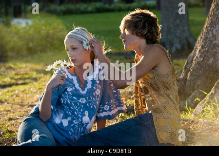 Vue d'un jeune couple vintage hippie des années 60, en mettant l'oreille derrière fleur Banque D'Images