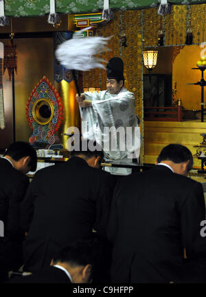 4 janvier 2012, Tokyo, Japon - Un prêtre shintoïste donne la bénédiction de Dieu à un groupe de personnes d'affaires traditionnels sur le premier jour d'affaires en 2012 à Kanda de culte au centre-ville de Tokyo, le mercredi, 4 janvier 2012. Des milliers de personnes se sont rendues pour célébrer la nouvelle année et faire leurs vœux dans une tradi Banque D'Images