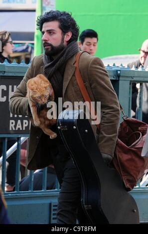 17 février 2012 - Manhattan, New York, États-Unis - l'Acteur OSCAR ISAAC dans le rôle de personnage principal Llewyn Davis porte un chat et guitare hors de la ville de ''1'' de la station de métro de train à Christopher Street dans le West village lors du tournage d'une scène du nouveau film du frère Coen ''Inside Llewyn Davis''. ''Insi Banque D'Images