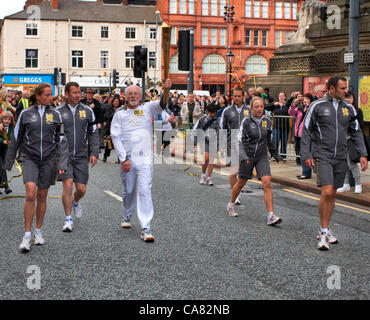 25/06/12, 07:20, Leeds, West Yorkshire, Royaume-Uni. Michael Healey, 71 à partir de Leeds porte la flamme, de Leeds Town Hall le jour 38 du relais de la flamme olympique. Banque D'Images