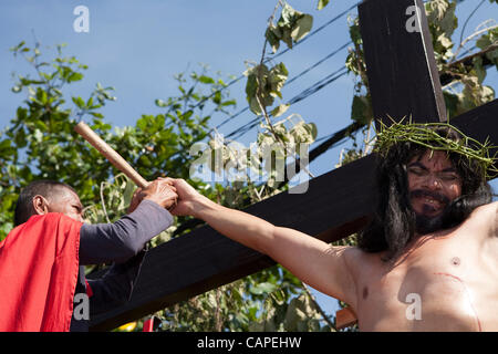 La ville de Cebu, aux Philippines, Good-Friday, 6.Avril 2012 : Gilbert, Bargayo d'être cloué à la croix pour la 17e Vendredi Saint. La dépose des ongles est extrêmement douloureux. Banque D'Images