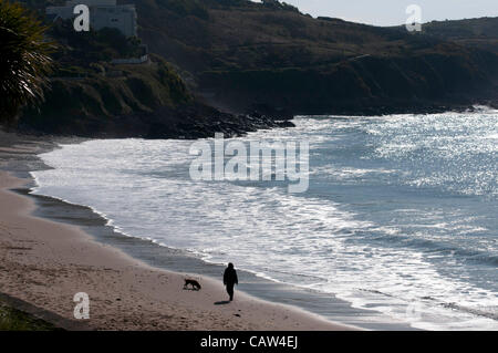 Swansea - UK - 24 avril 2012 - Une femme promener son chien sur la plage de Langland près de Swansea aujourd'hui dans le chaud soleil du printemps. Banque D'Images