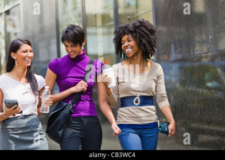 Trois businesswomen walking outside office Banque D'Images