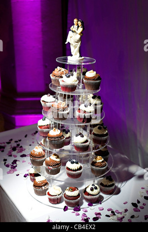 Coupe de mariage gâteaux sur table avec figurines sur le dessus. Banque D'Images