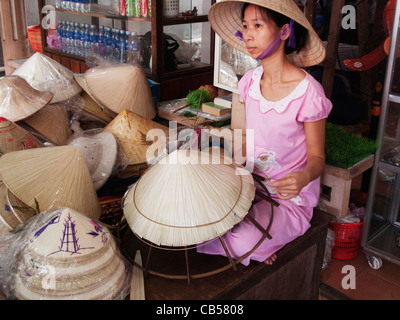 Femme porte des chapeaux de paille coniques à Hue, Vietnam Banque D'Images