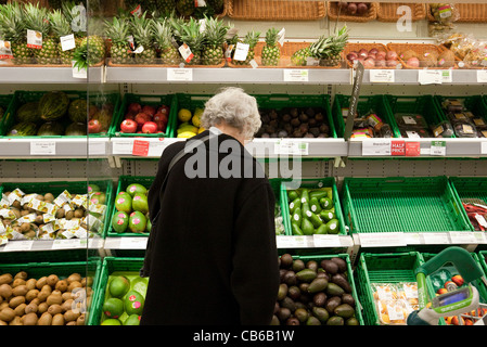 Old Lady shopping pour veg dans un supermarché Waitrose UK Banque D'Images
