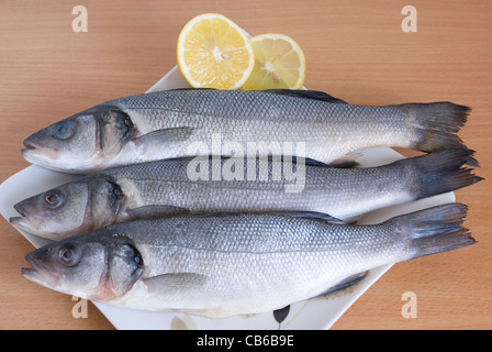 Le poisson frais et les rondelles de citron sur la plaque Banque D'Images