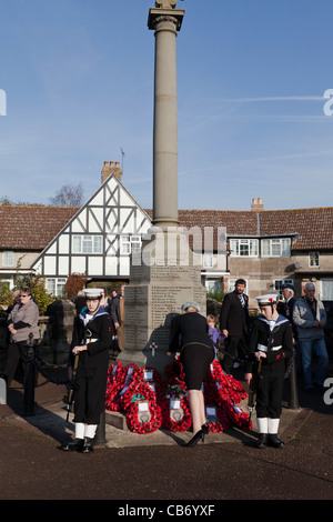 Cénotaphe À LYDNEY GLOS SUR DIMANCHE DU SOUVENIR 2011AVEC POPPY COURONNES ET SCOUTS MARINS QUI MONTENT LA GARDE ET DAME PORTANT COURONNE. Banque D'Images