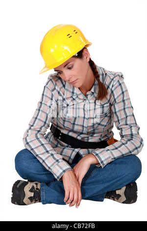 Sad female construction worker Banque D'Images