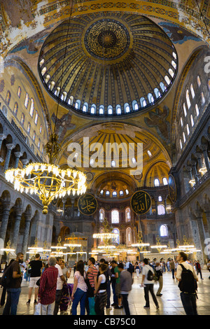 La Turquie, Istanbul, Sultanahmet, Sainte Sophie Tourisme touristes sous le dôme avec des peintures murales et des lustres dans la Nef. Banque D'Images