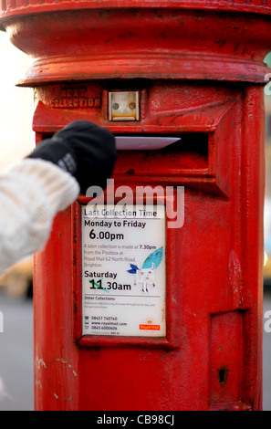 L'affichage d'une carte de Noël en rouge britannique post box en temps UK Banque D'Images