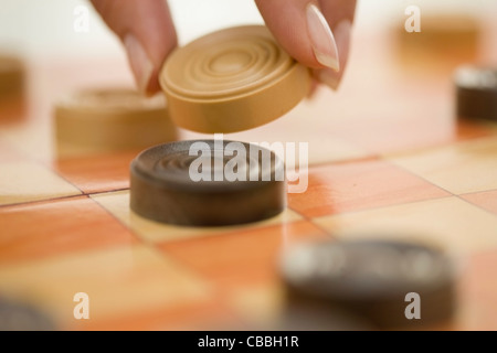 Close up of woman playing checkers Banque D'Images