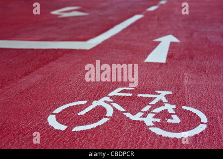 Route cyclable rouge avec panneau blanc et des flèches dans la ville de Graz, en Styrie, Autriche Banque D'Images