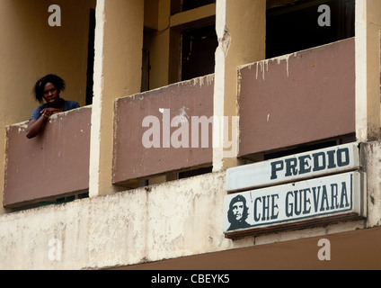 Femme sur le balcon d'un hôtel délabré à Malanje, Angola Banque D'Images