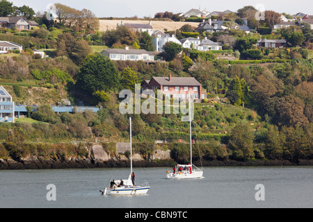 Deux yachts motoring dans port de Kinsale, dans le comté de Cork, en République d'Irlande. Banque D'Images