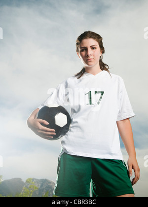 Young soccer player holding ball Banque D'Images