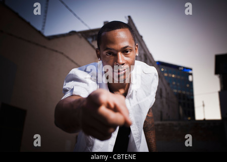 Black man standing outdoors pointing Banque D'Images