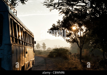 Indian bus / autocar voyager tôt le matin au lever du soleil à la campagne. L'Andhra Pradesh, Inde Banque D'Images