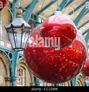 Grandes boules de décoration de Noël rouge à Covent Garden London Banque D'Images