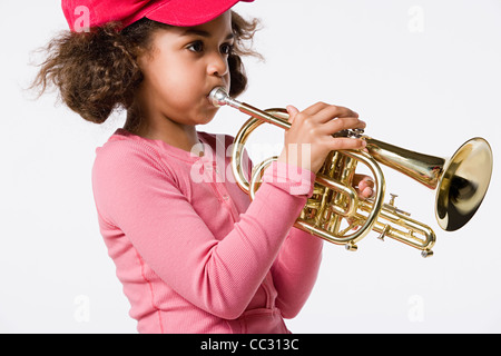 Studio Portrait of Girl (8-9) playing trumpet Banque D'Images